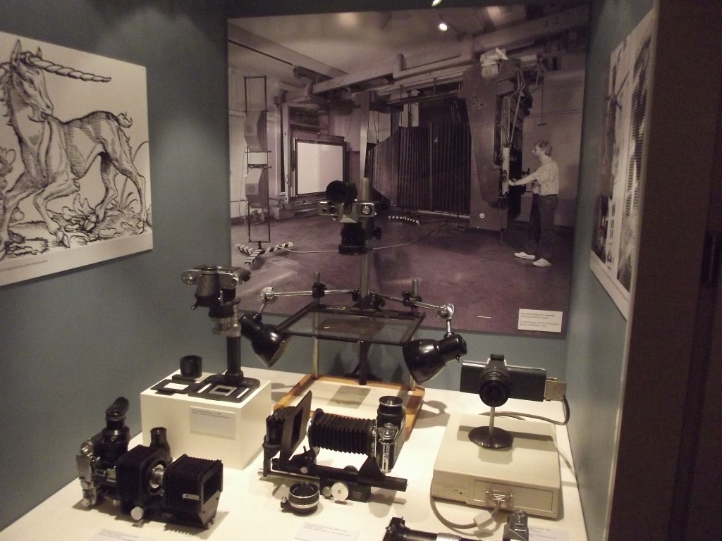 Photographic equipment, note the photo in the background of a large process camera.