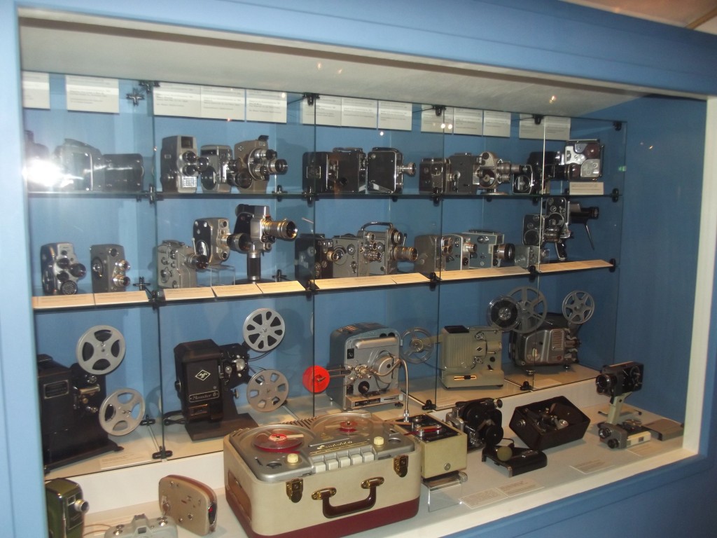 A seelction of cine cameras and projectors, mostly 8 mm. There is also a large tape deck; the only way to have sound in home movies before the advent of the Super 8 format was to use one of these machines. There were even various gadgets to synchronise film and sound.