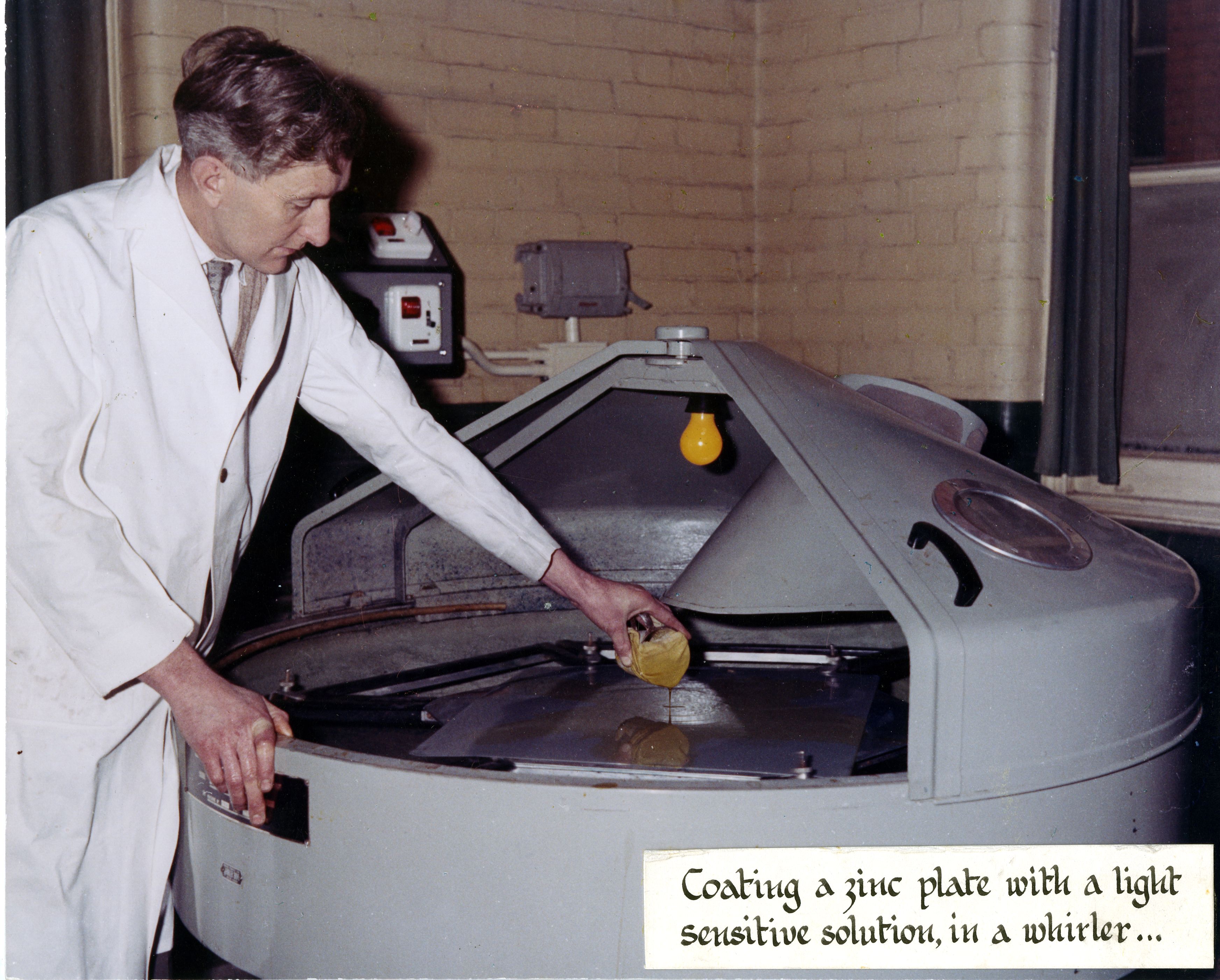Coating a zinc plate with a light-sensitive solution in a whirler,