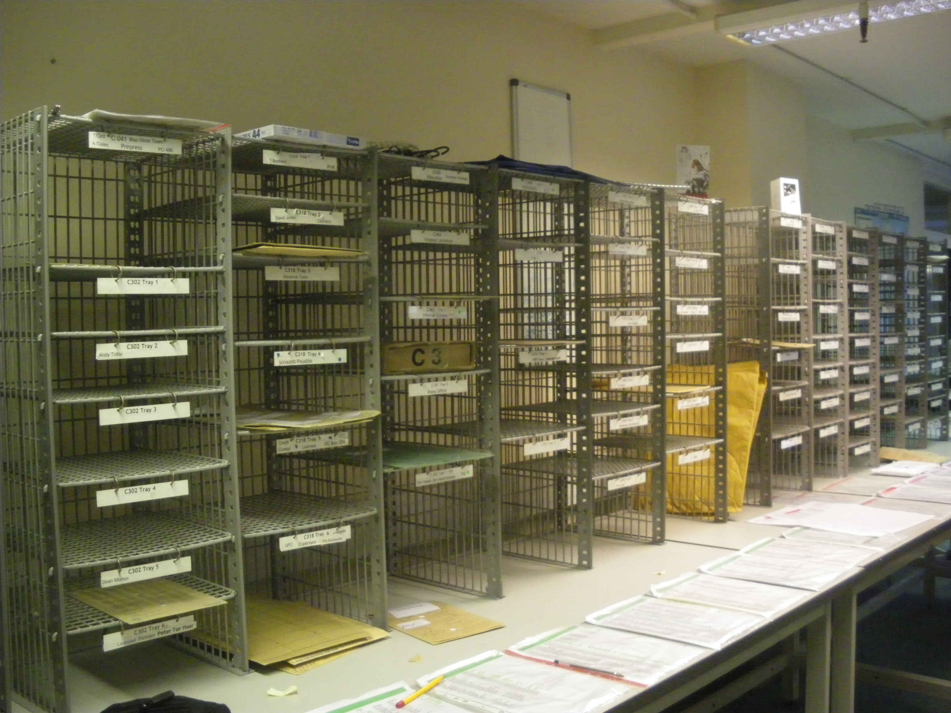 Green round mail racks in the Post Room (W005)