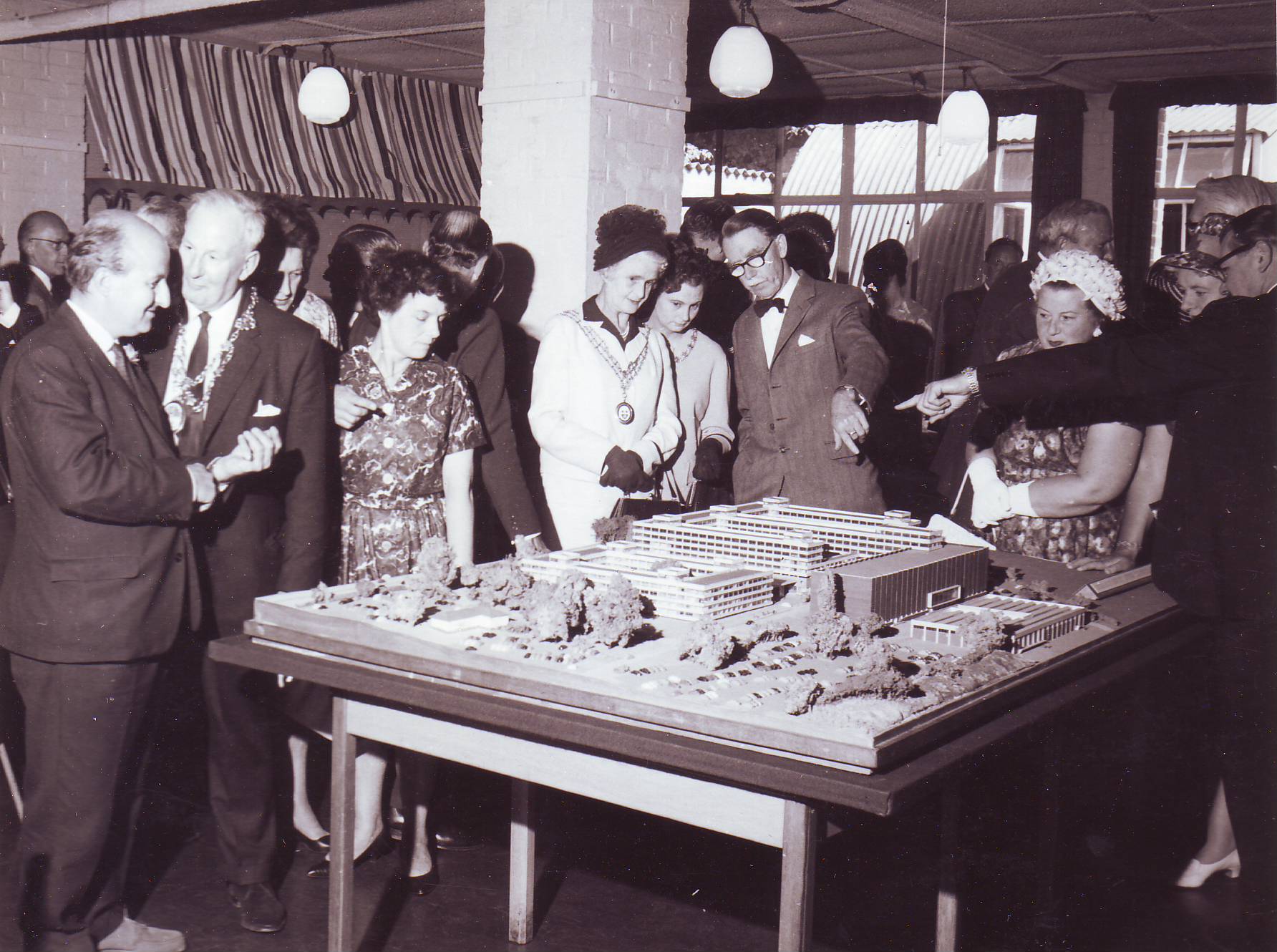 Dignitaries inspect a model of the Maybush building